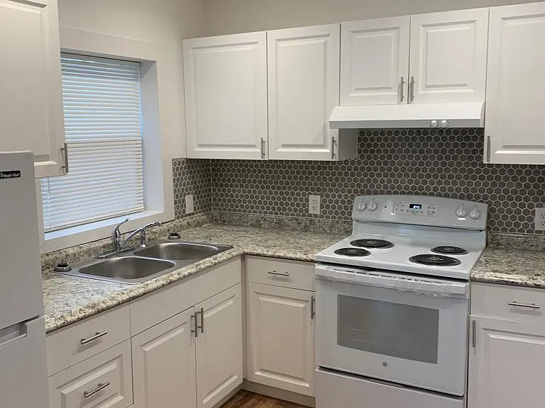 Comfortable, well-lit kitchen with a fridge and essential amenities. Lakeland, FL