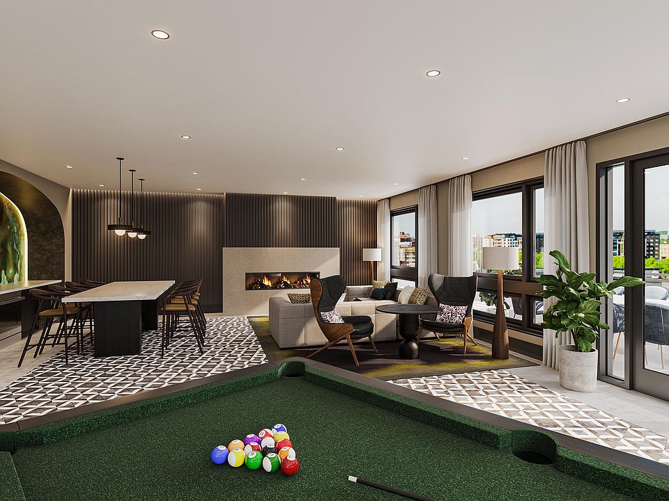 Rooftop lounge with billiards, fireplace, and outdoor terrace with sweeping views towards the Capitol.