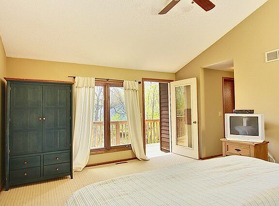 Vaulted owner's suite opens to deck.