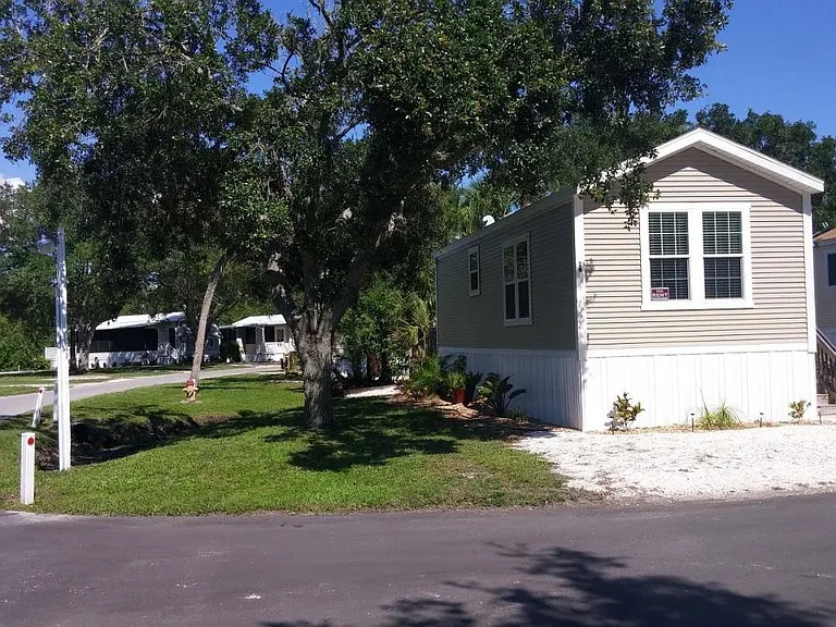 Front view, corner lot & shaded grass yard