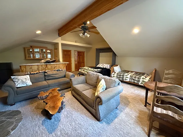 Huge game room with queen murphy bed, twin bed two couches, and wet bar