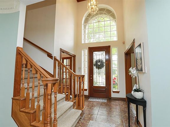 TWO STORY ENTRY: High ceilings in an entry hall always make for a grand entrance. Doorways to the left and right of the front door are the formal dining room and the handsome study.