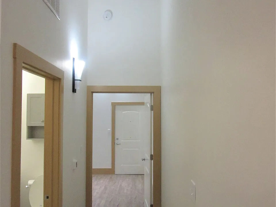 hallway looking towards bedroom - note far door in the shot is to interior commons hallway. This is for wheelchair access.