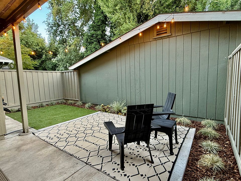 Private, fenced, backyard with landscaping maintained by automatic irrigation. Lawn is premium artificial turf.