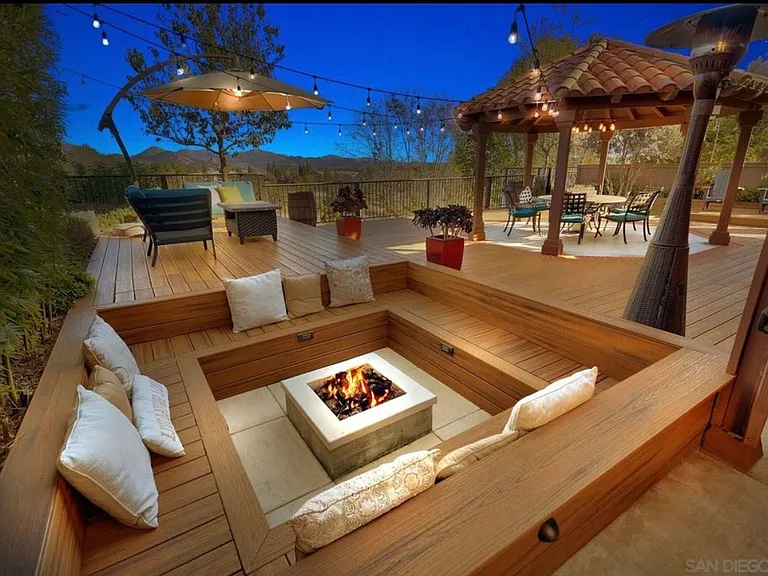Designed for entertaining and relaxation, this spectacular backyard features expansive decking, a gazebo, firepit lounge, and stunning easterly views.