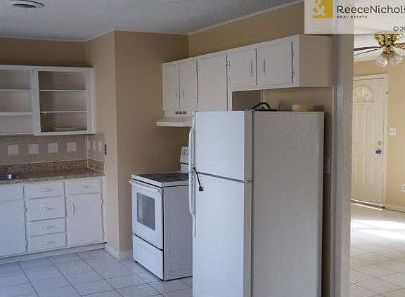 Kitchen looking back through family room to front door