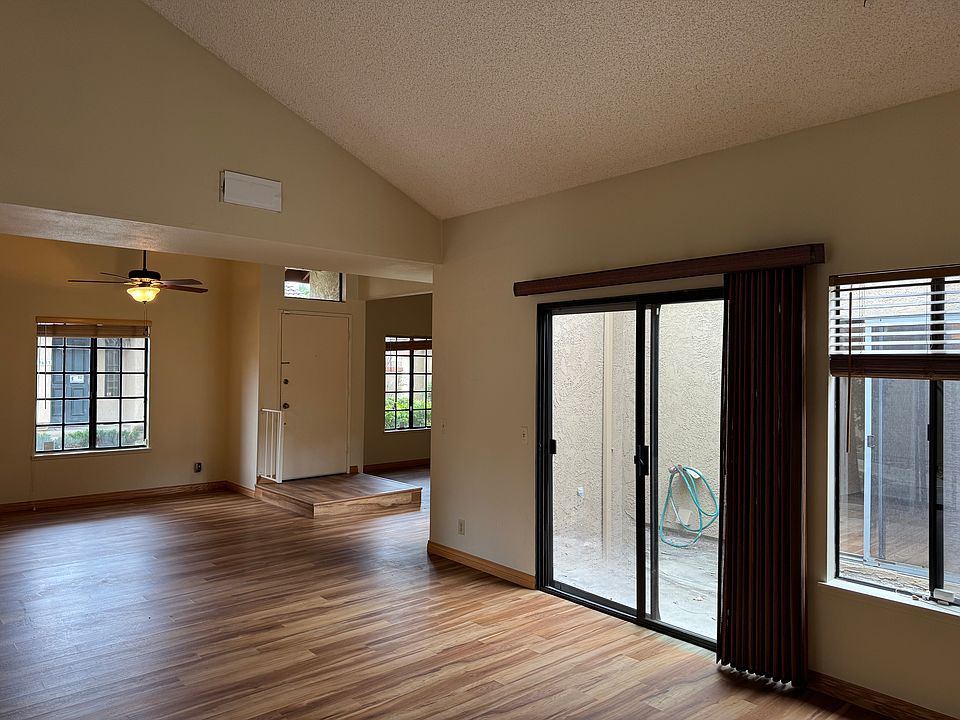 The front door with a step down into the open floor plan. Dinning room and living room.
