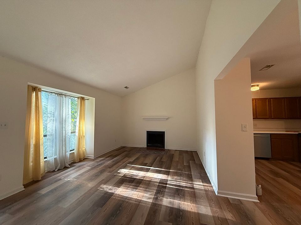 The floor plan is open, but the kitchen work area is not in the living room. The dining area is open to the living room and also has a slider to the deck.