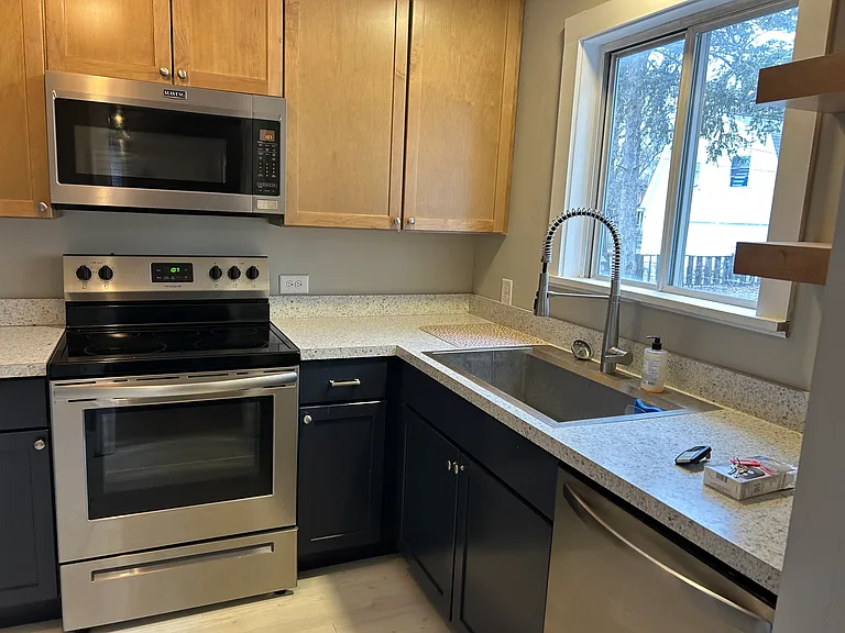 Updated kitchen with dishwasher, stove, microwave, and refrigerator