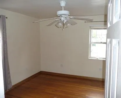 Bedroom, hardwood oak floor, lots of natural light, ceiling fan, air conditioner and closet.