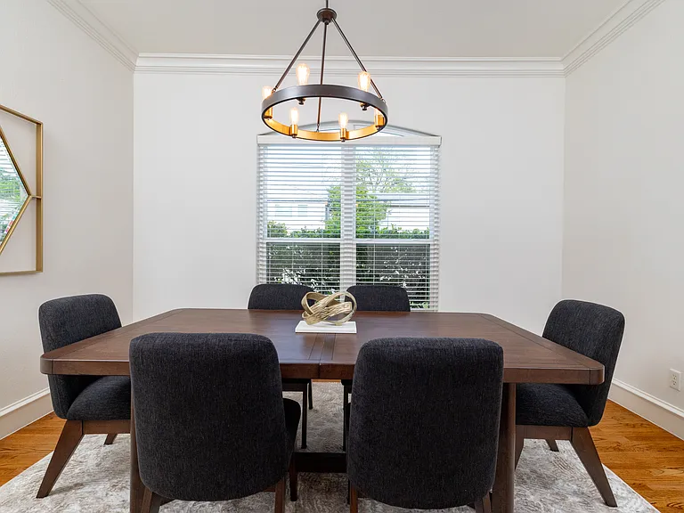 Elegant formal dining room with a striking modern chandelier.