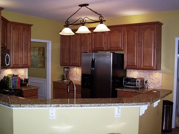 Kitchen with Granite, Tile floor/backsplash, and stainless appliances.