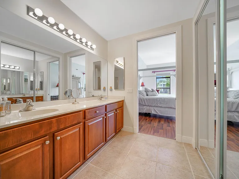 Master bath vanity out to master bedroom and views of water and palms.