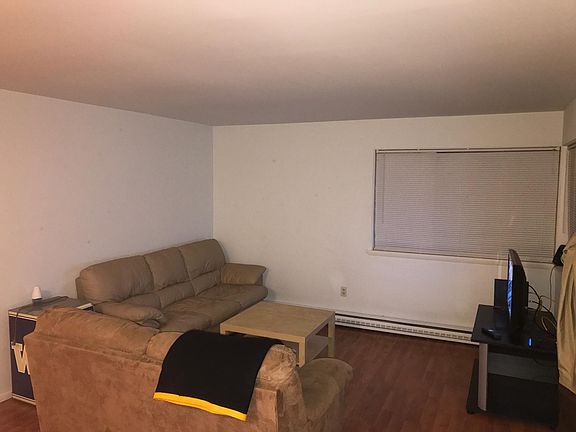 Living room w lots of room for couches and TV. Lots of windows and daylight.