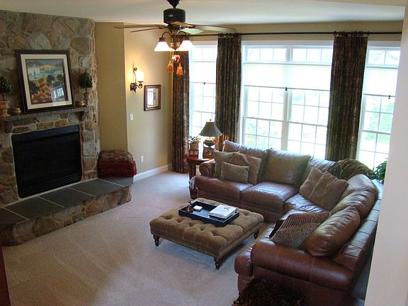 Family room with wall of windows and stone gas fireplace
