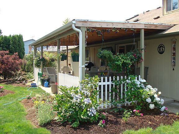 New covered patio and flower beds