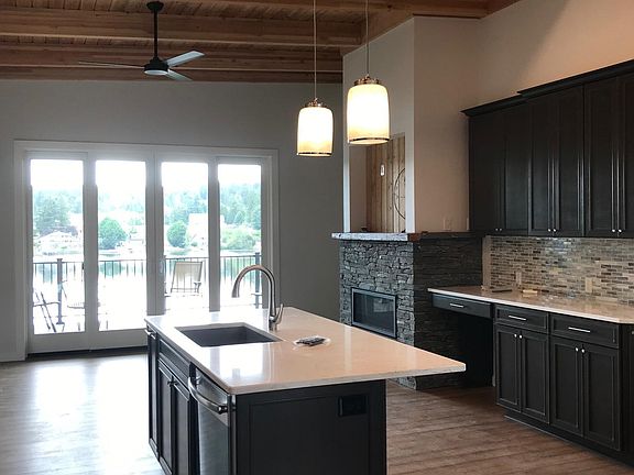 kitchen island, gas fireplace, double sliding glass doors to large deck overlooking lake