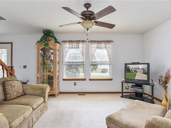 Another view of the family room with the ceiling fan light. The double windows face out onto the dead end street.