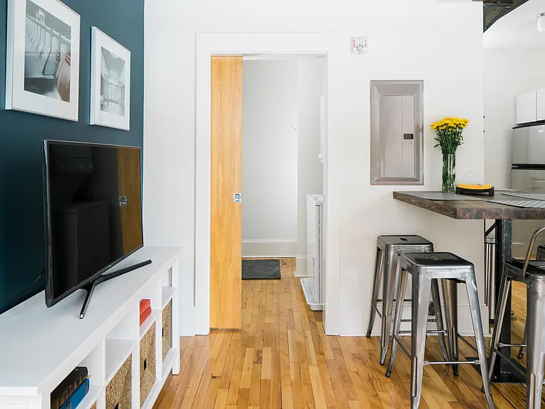 Updated bathroom with pocket door includes stacked washer/dryer and tiled shower