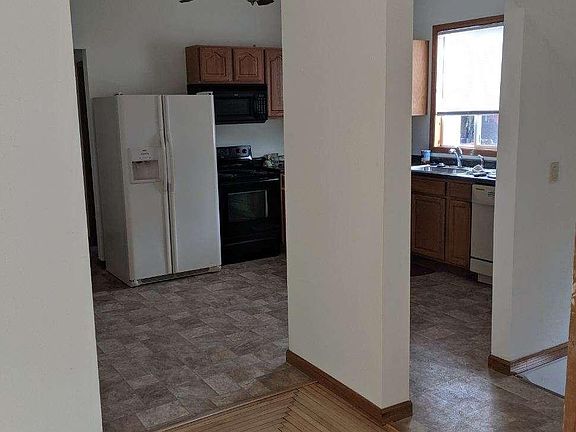 Living room opens to big, open kitchen with a full set of appliances