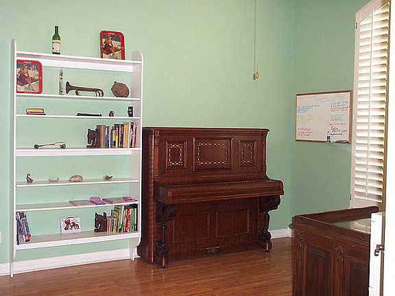 The study located just inside the entry has laminate flooring and french doors.