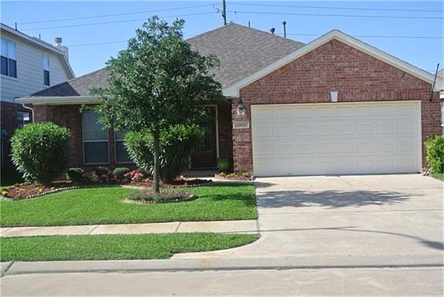 24606 Tribeca Lane front elevation shows neat, well maintained landscaped front yard.