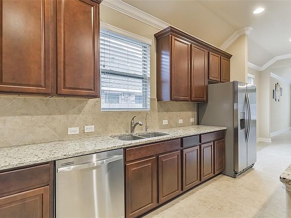 Bright kitchen with custom cabinetry, granite counters, and tons of storage space.  The dishwasher was never used!