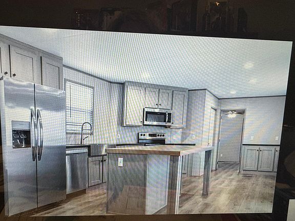 Open concept from kitchen and living. View of the front yard and back yard, stylish farmhouse sink!