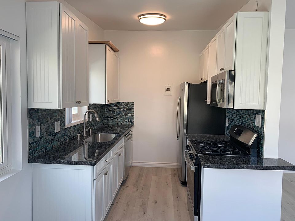 The brand new gourmet kitchen has tons of soft close cabinets and top of the line stainless gas range/oven, microwave, refrigerator/freezer & diswasher plus beautiful blue granite countertops and ocean tile backsplash.