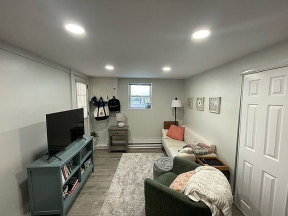 bright living room with high hats and two windows