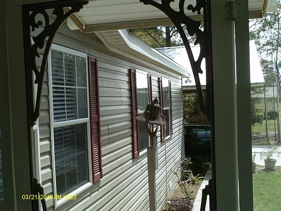 Front view toward carport from covered front deck