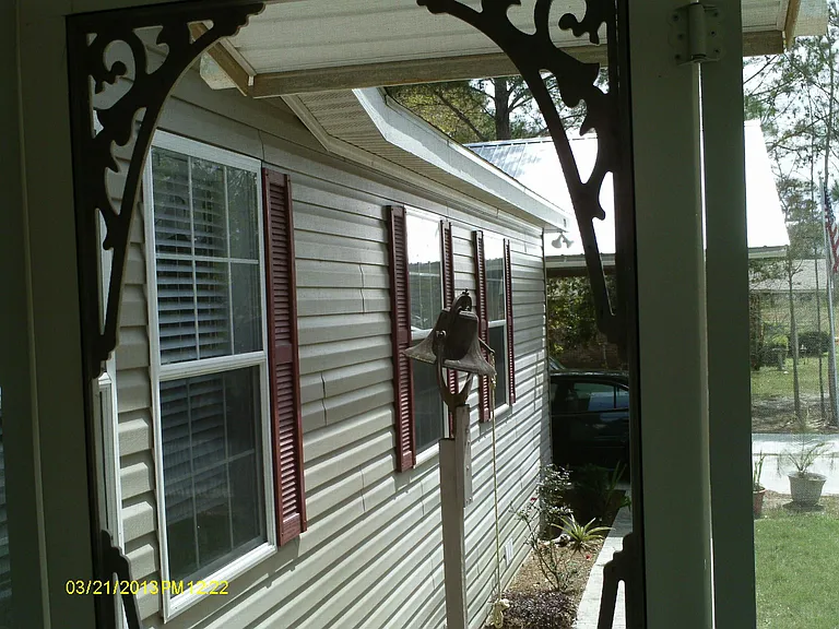 Front view toward carport from covered front deck