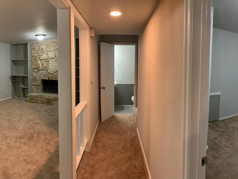 view of living room, hall to powder bath and downstairs bedroom