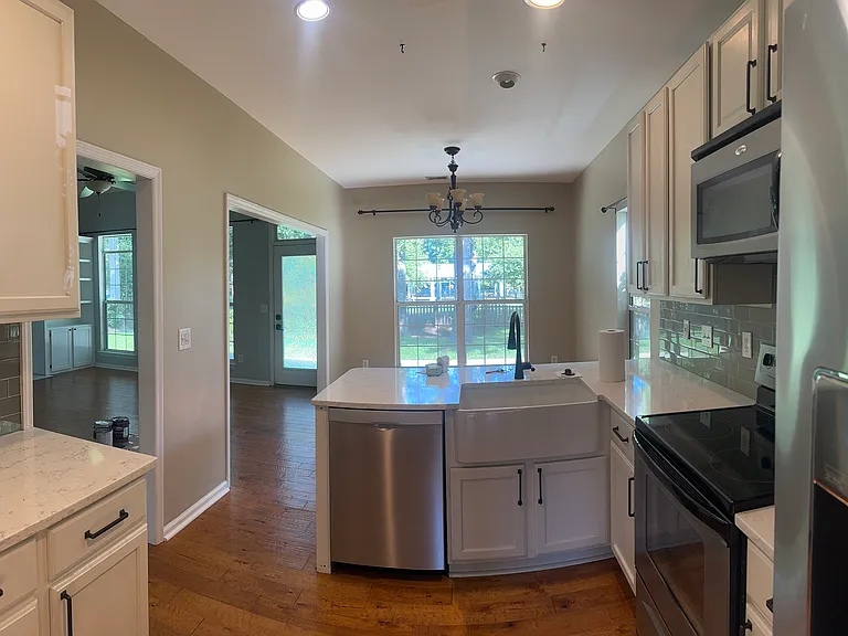 Kitchen looking onto Breakfast Nook (empty)
