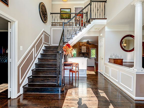 Stunning entry foyer with wrought iron staircase