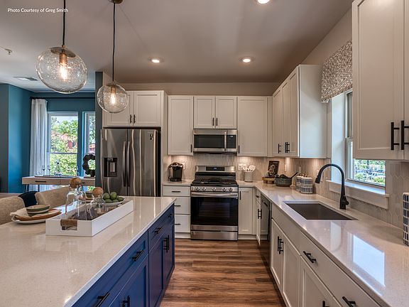 Each kitchen boasts stainless steel appliances and sleek granite countertops.