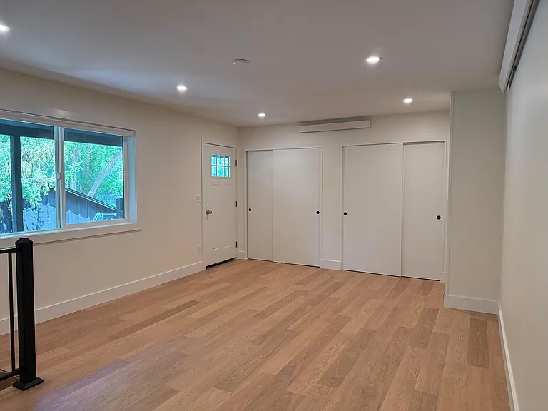 View of living room and entrance. 2 large closets for storage in living room