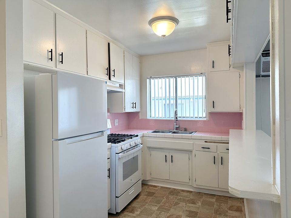 Kitchen with gas stove and refrigerator