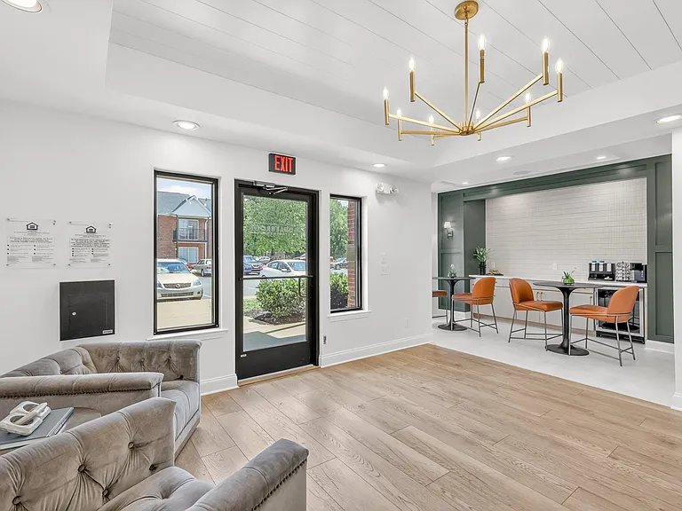 Comfortable resident gathering space featuring a complimentary coffee station and lounge seating.