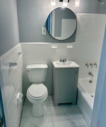 Updated Bathroom with Vanity, Flooring, Mirrow and Lighting