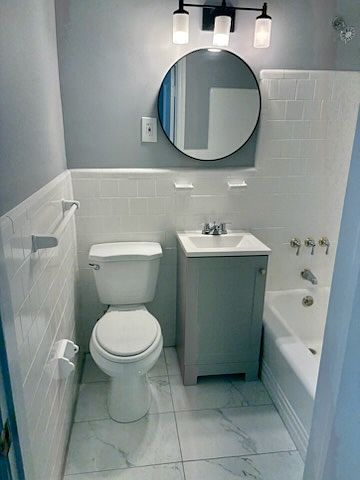 Updated Bathroom with Vanity, Flooring, Mirrow and Lighting