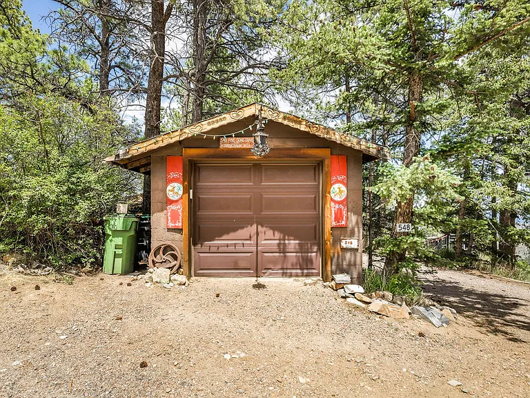 One-car garage and view of house from main road (showing privacy)