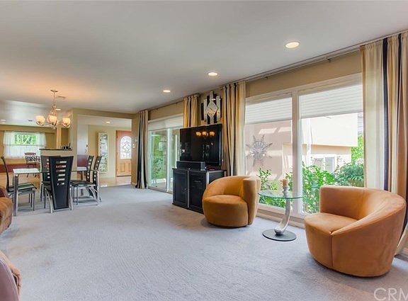 The living room is filled with natural light and provides another calm, welcoming view of the back yard.