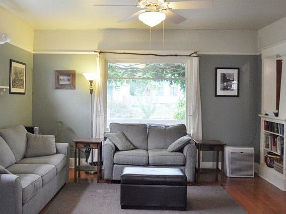 Light filled living room with built-in book shelves.