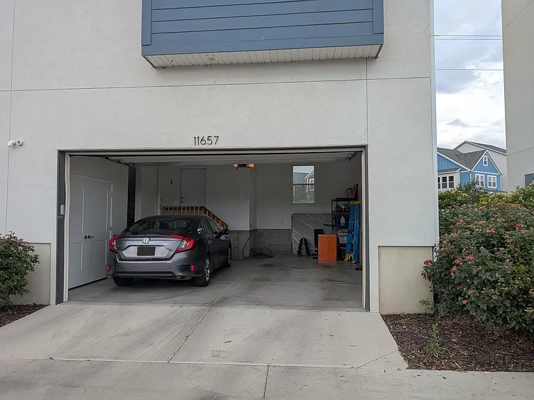 2 car garage with storage space and EV charging outlet