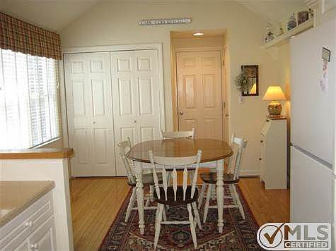 Country kitchen with gleaming floors and convenient laundry area - garage entrance.