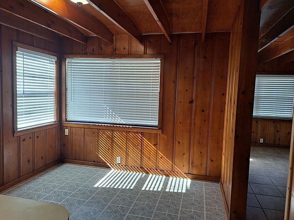Dining area with full windows in kitchen and bar for stools as well