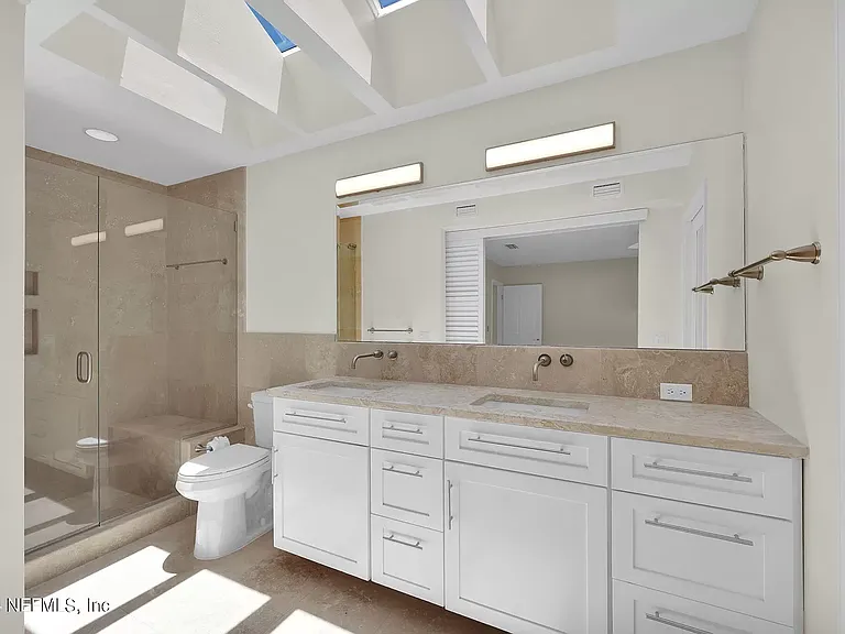 Master bathroom shower, walk in closet on right