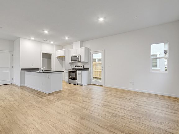 living room and backyard view and garage door seen with kitchen