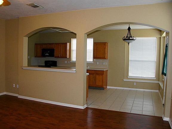 Architectural arches separate the family room from the kitchen and breakfast room.